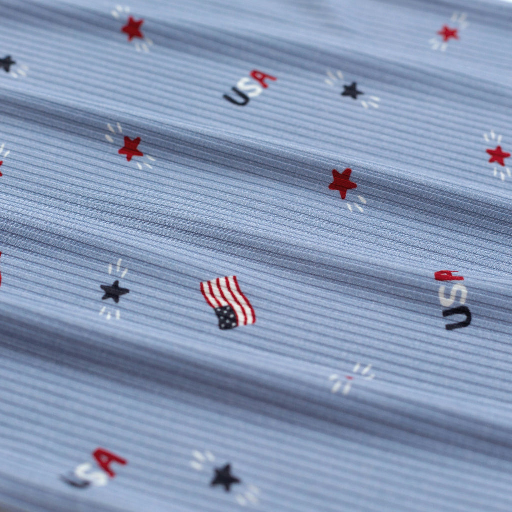 Close-up of fabric with USA-themed pattern including stars and American flags.
