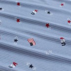 Close-up of fabric with USA-themed pattern including stars and American flags.