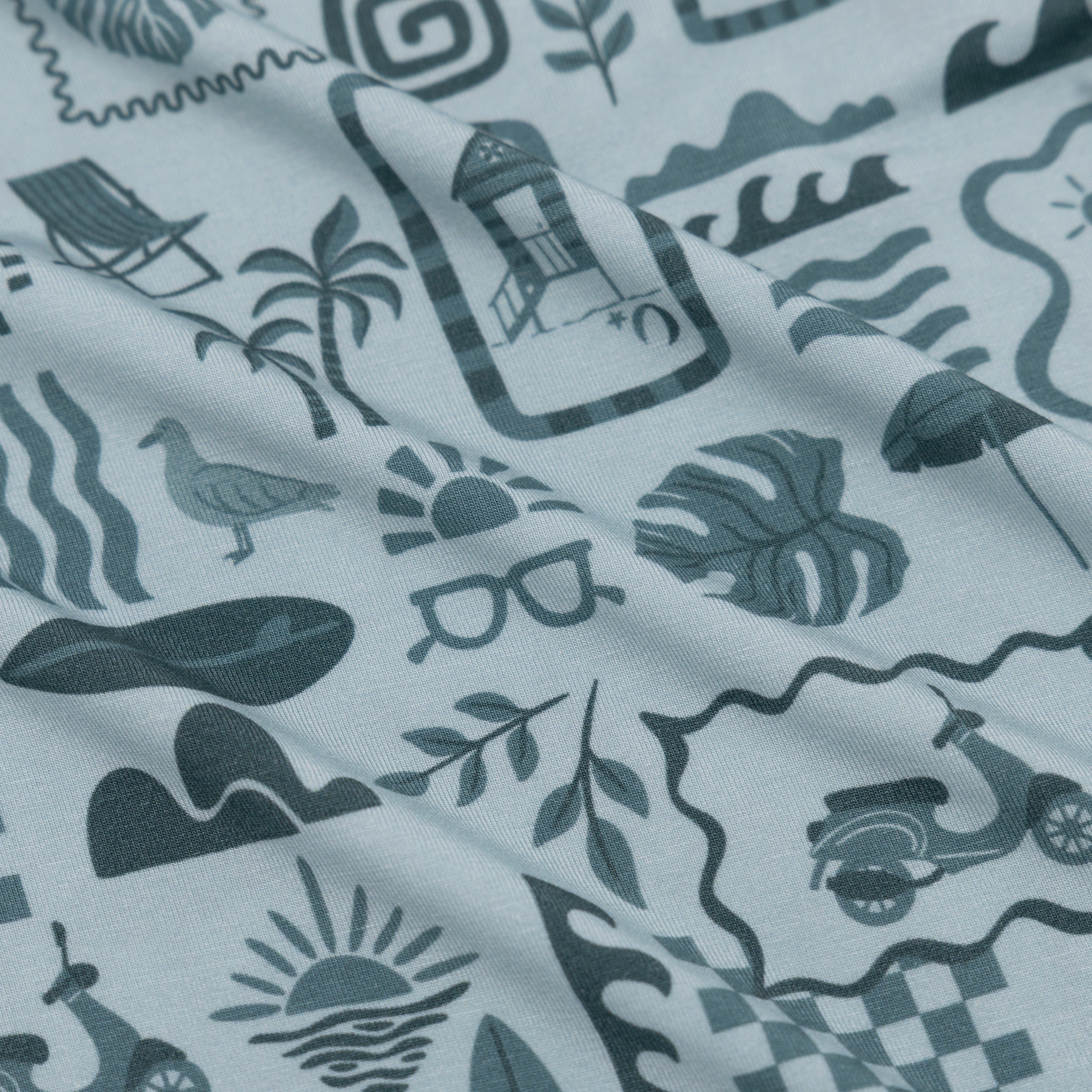 Fabric with a pattern of summer icons and symbols on a white background