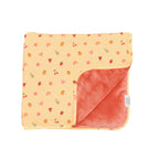 Baby blanket with colorful fruit pattern on one side and solid color on the other, on a white background.
