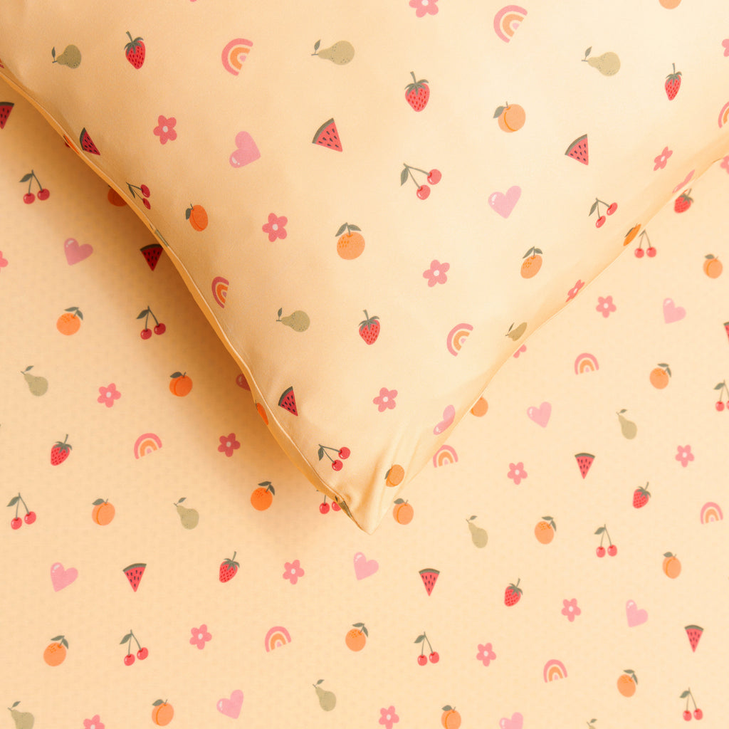 Yellow fabric sheet with colorful fruit and rainbow pattern