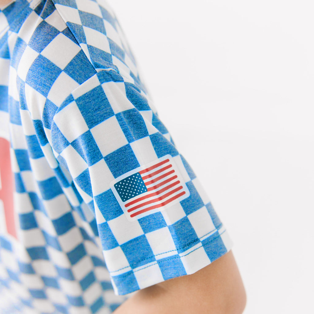 Close up shot of a blue and white checkered sleeve with American flag design on a white background