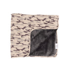 Camouflage-patterned blanket with dark backing on a white background