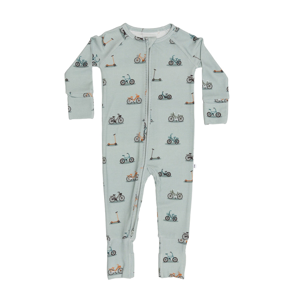 Children's onesie with bicycles & scooters pattern on a white background