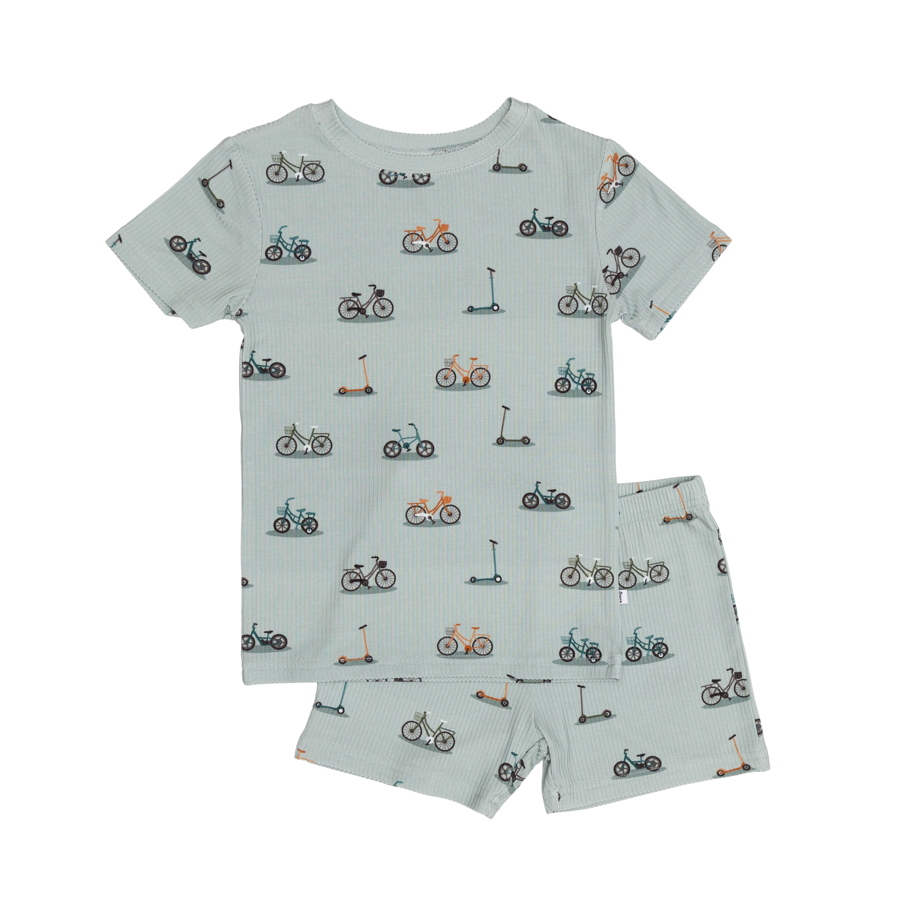 Children's pajama shorts set with bike and scooter pattern on a light blue background