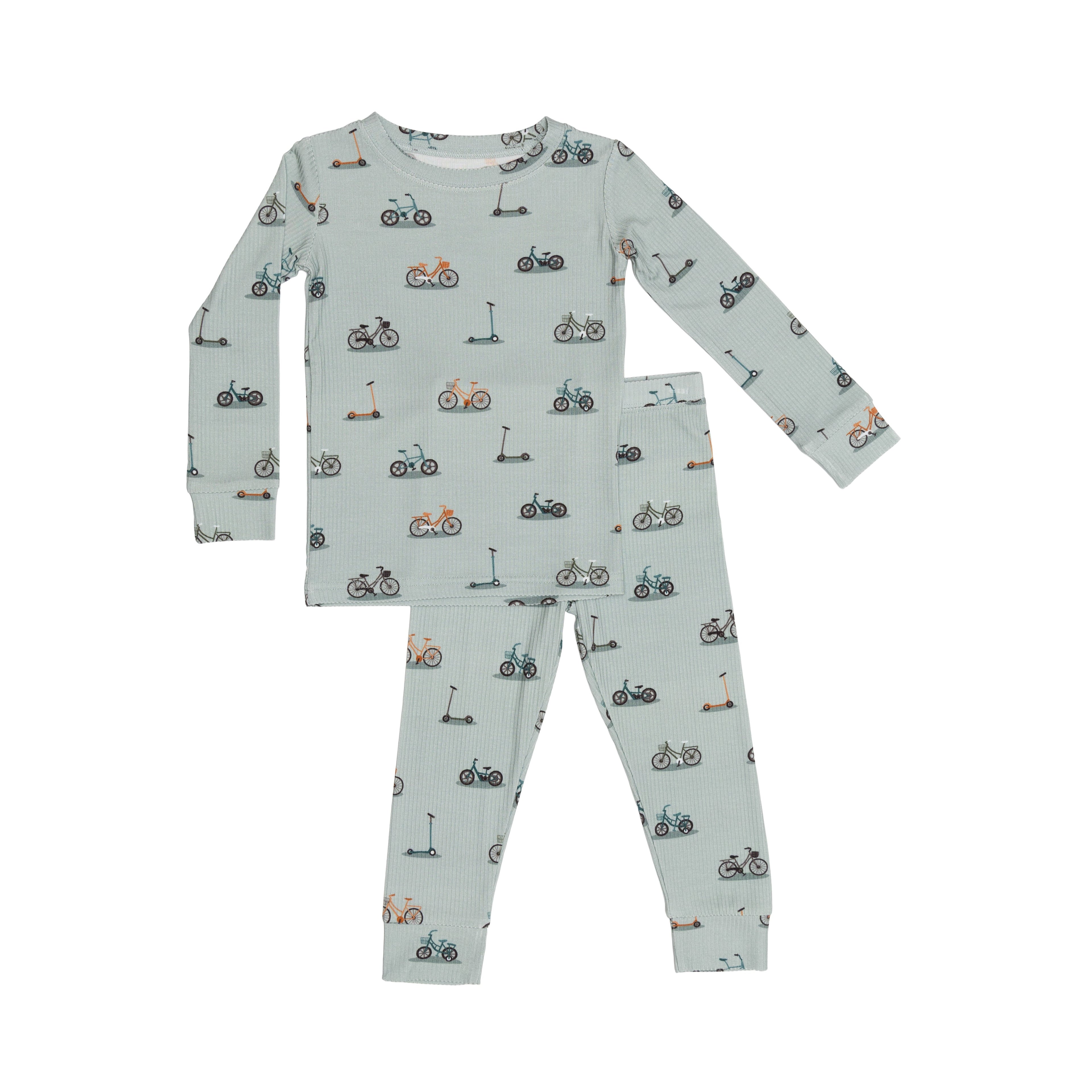 Children's pajama set with bikes and scooter pattern on a light blue background