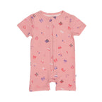 Pink baby romper with colorful girly patterns on a white background