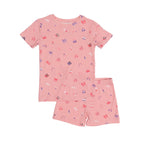 Pink children's pajama shorts set with girly patterns on a white background