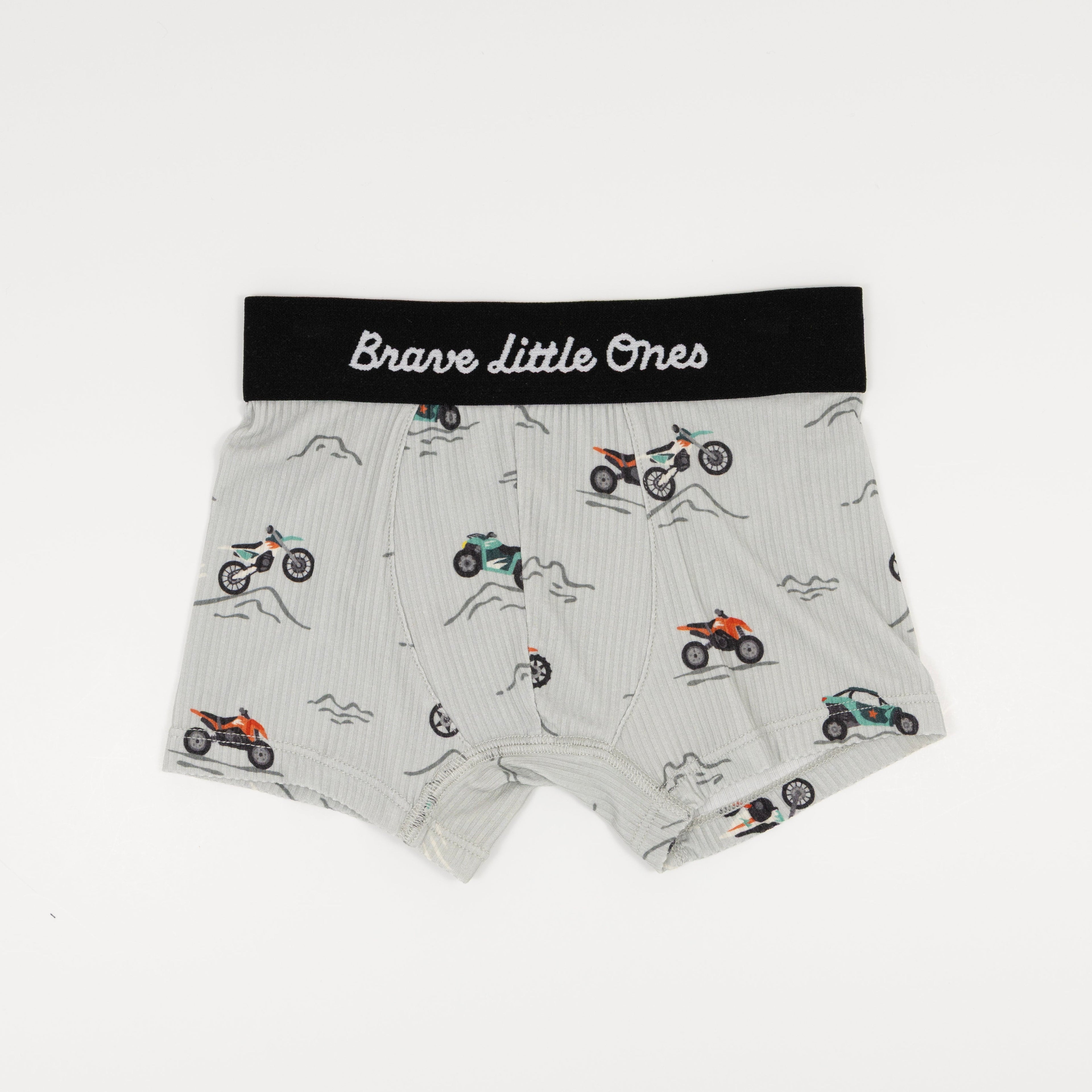 Children's underwear with dirt bike pattern and 'Brave Little Ones' label on a white background