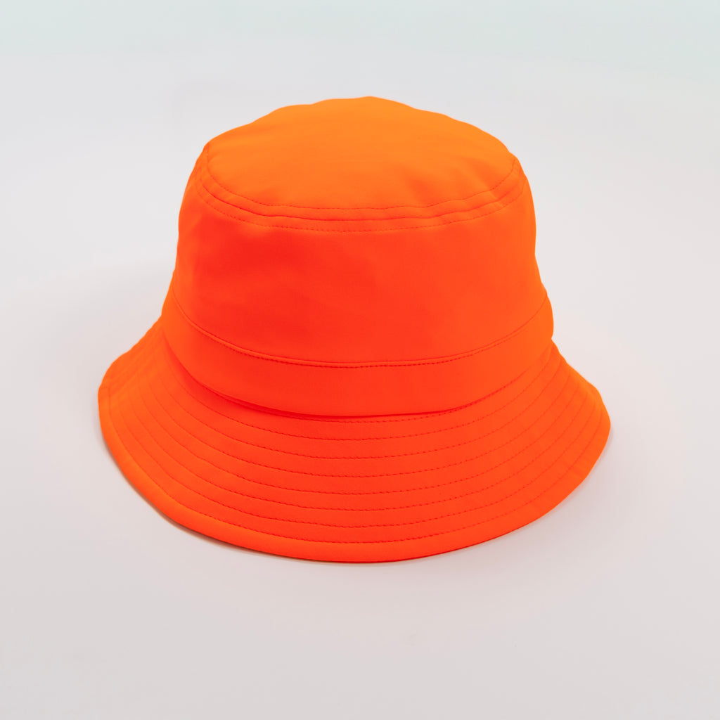 Orange bucket hat with a strap on a plain background