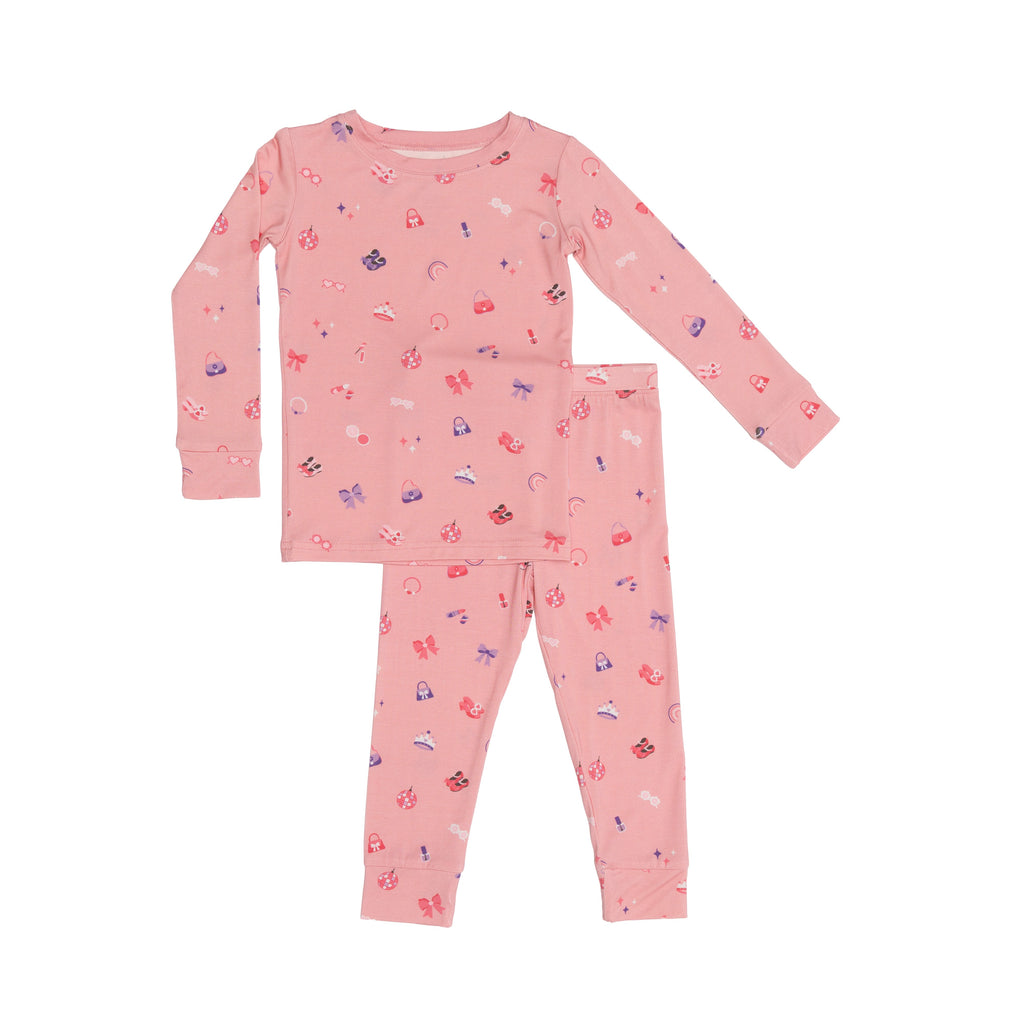 Pink children's pajama set with a girly pattern on a white background