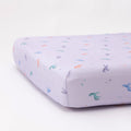 Fitted crib sheet with colorful unicorn patterns on a white background