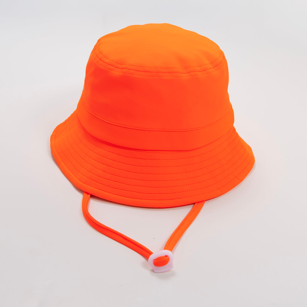 Orange bucket hat with a strap on a plain background