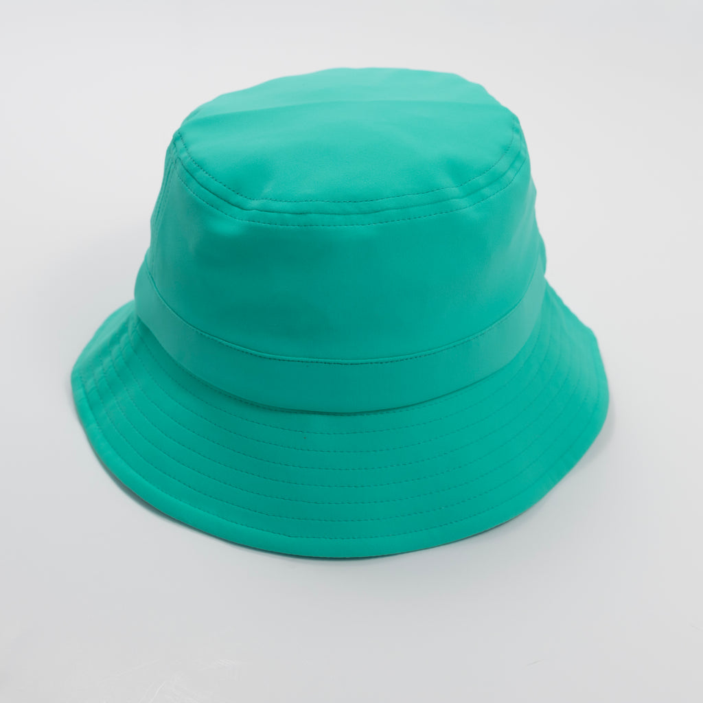 Turquoise bucket hat with a strap on a plain background