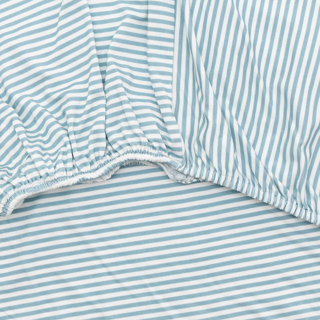 Close-up of a fitted sheet with blue and white stripes