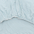 Close-up of a fitted sheet with blue and white stripes