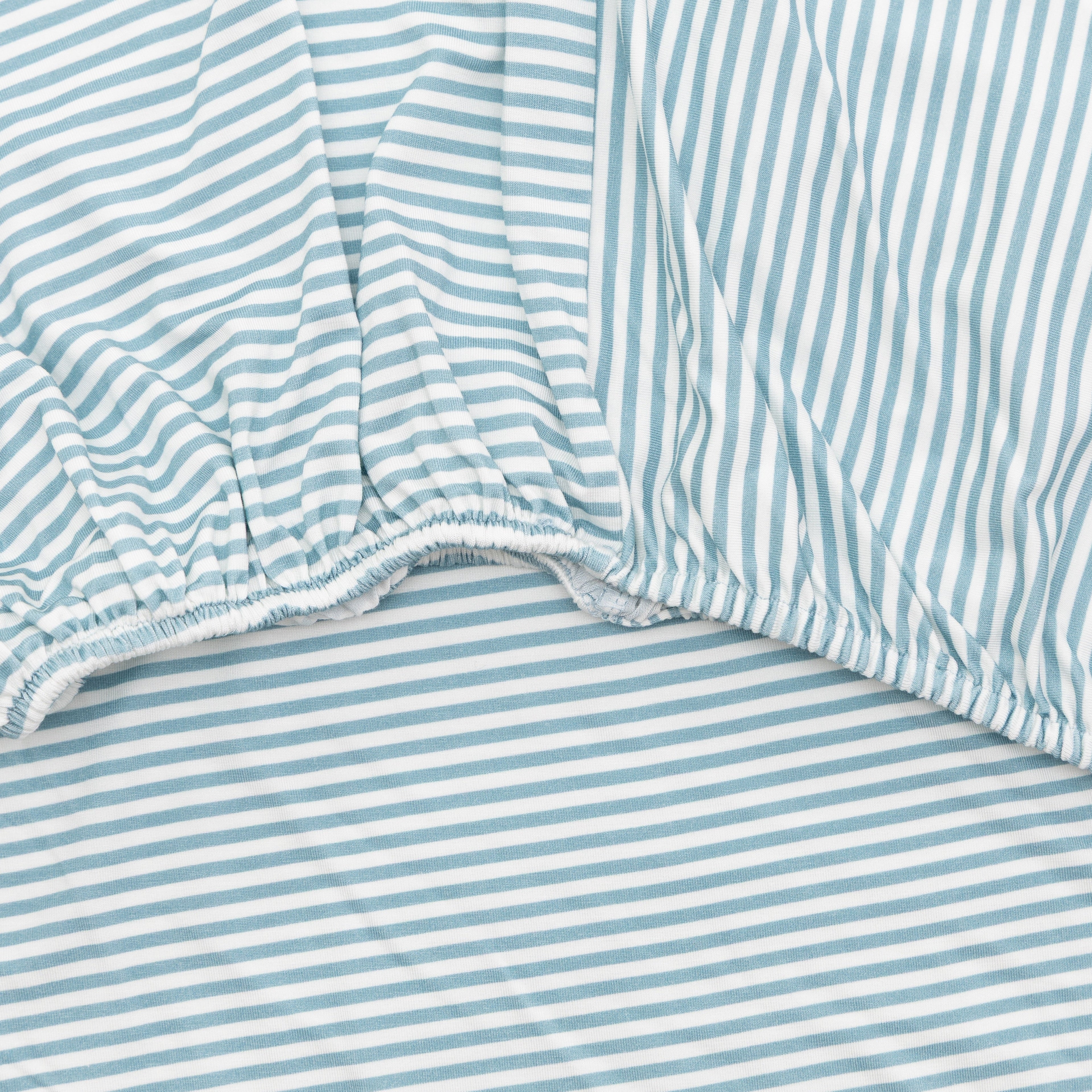 Close-up of a fitted sheet with blue and white stripes