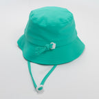 Turquoise bucket hat with a strap on a plain background