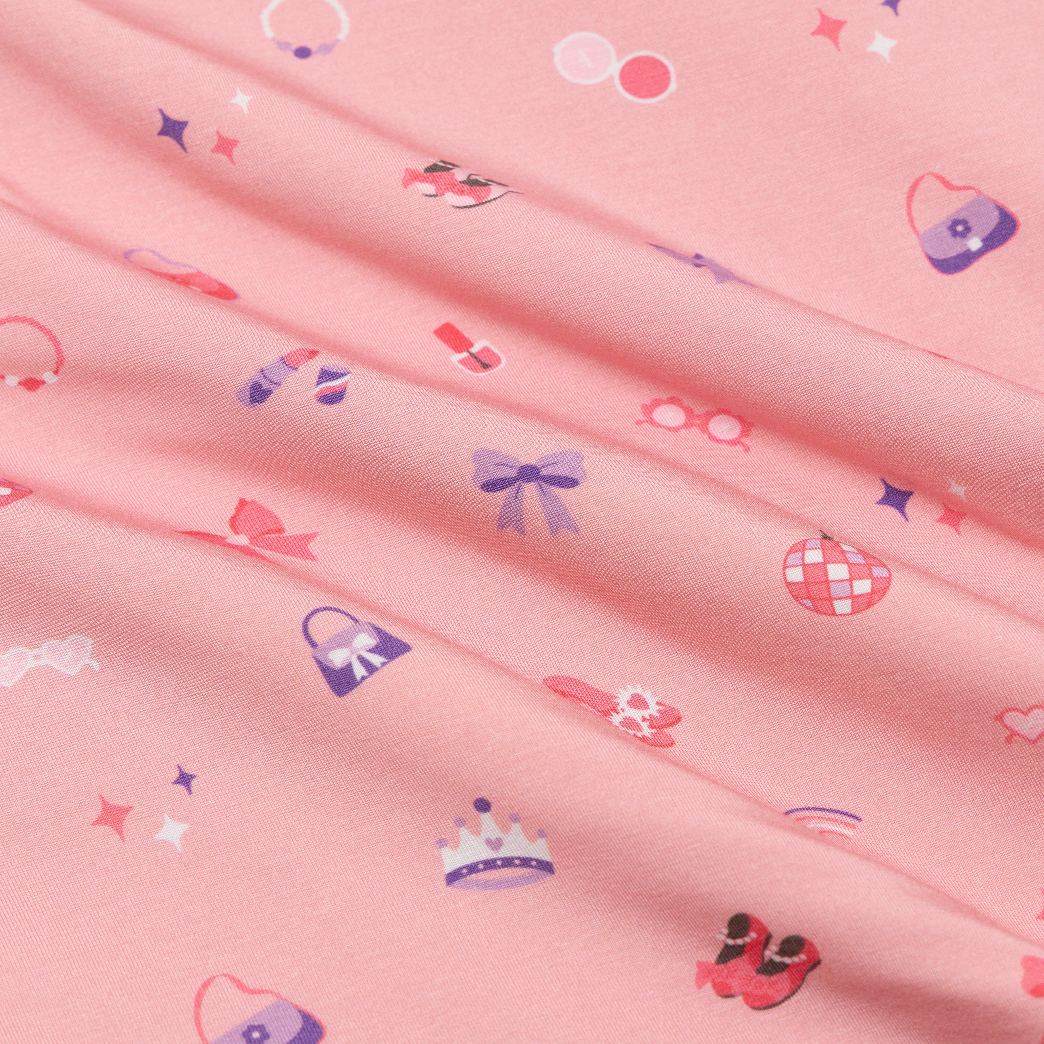 Pink fabric with small colorful patterns including bows and hats.
