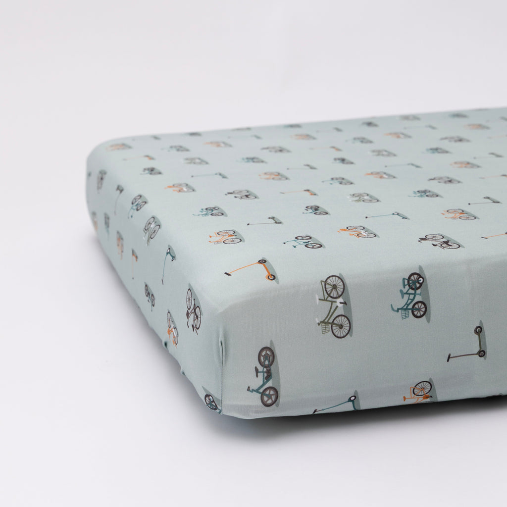 Fitted sheet with bicycle pattern on a light blue background