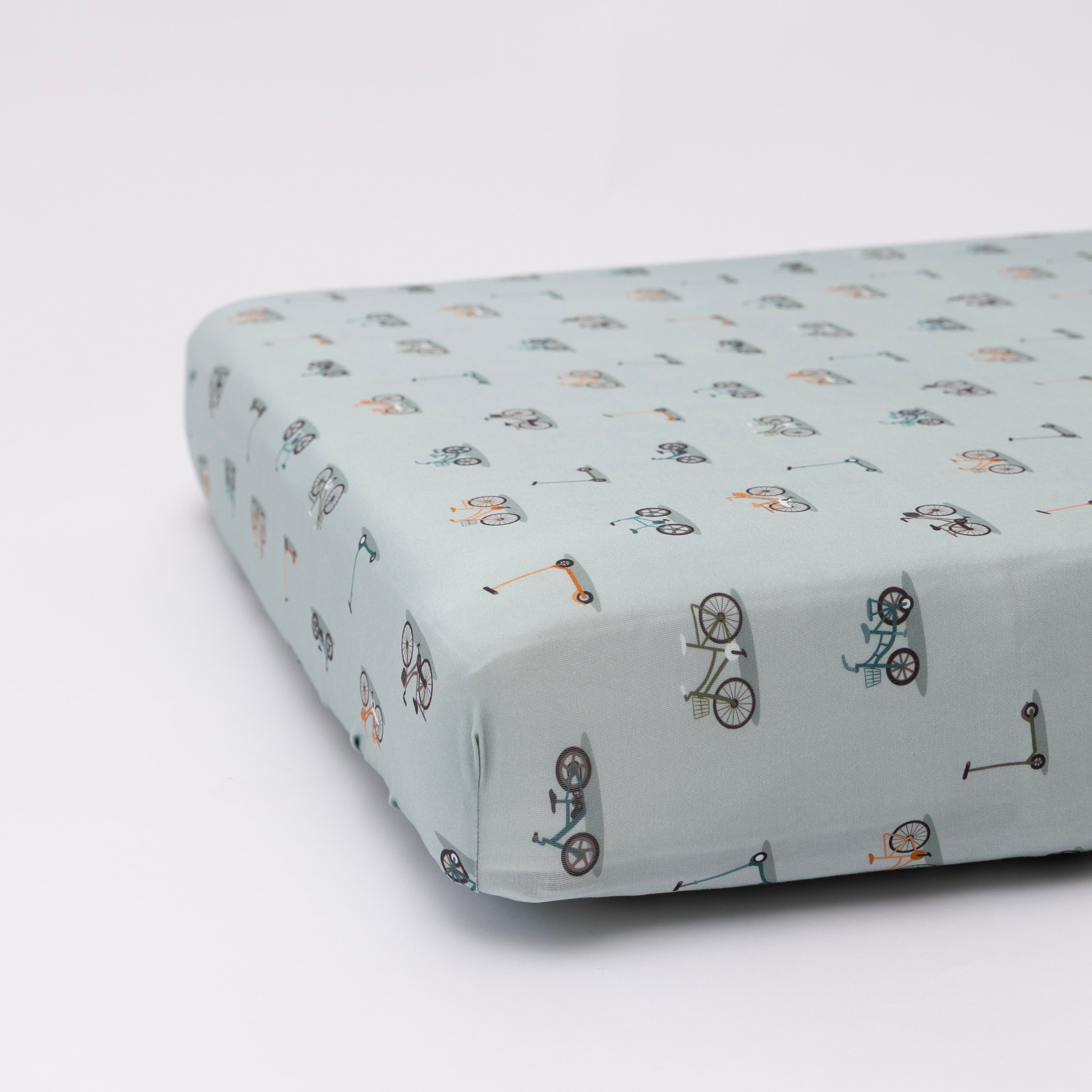 Fitted sheet with bicycle pattern on a light blue background