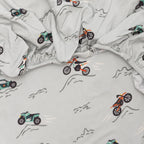 Close up shot of a fitted crib sheet with dirt bike pattern