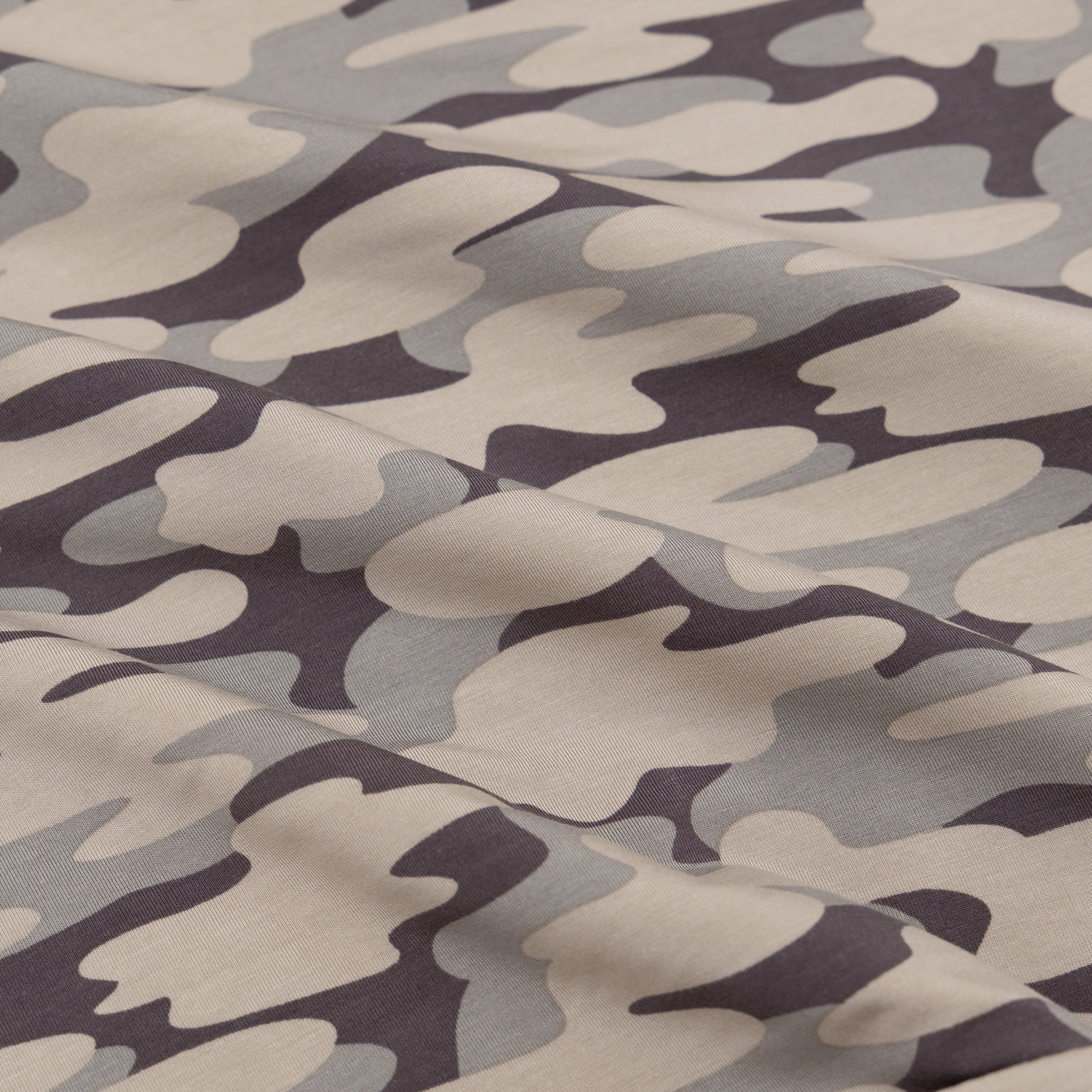Camouflage pattern fabric in shades of brown, gray, and black.