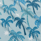 Fabric shot of blue palm trees on a light blue background