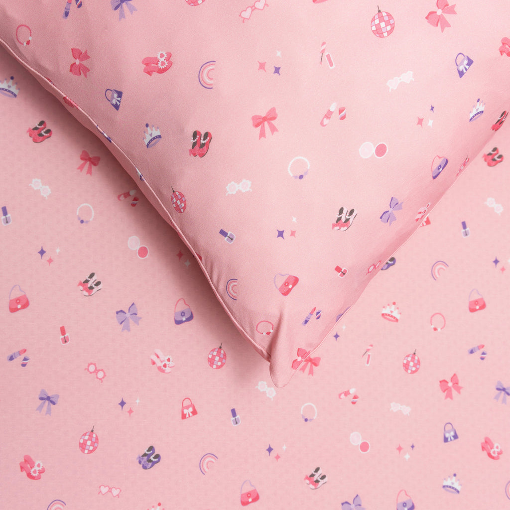 Close up of pink sheets with small colorful patterns