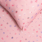 Close up of pink sheets with small colorful patterns