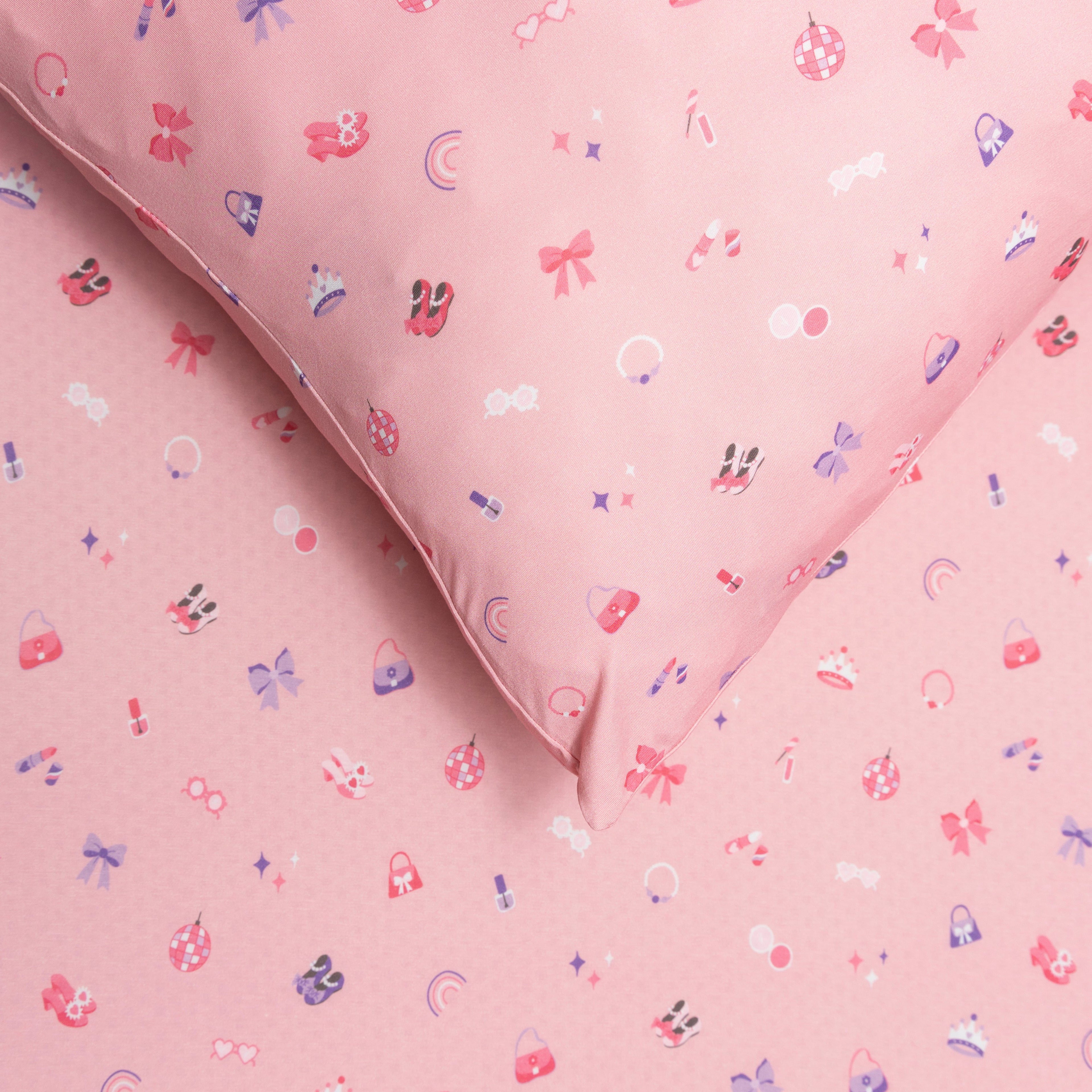 Close up of pink sheets with small colorful patterns