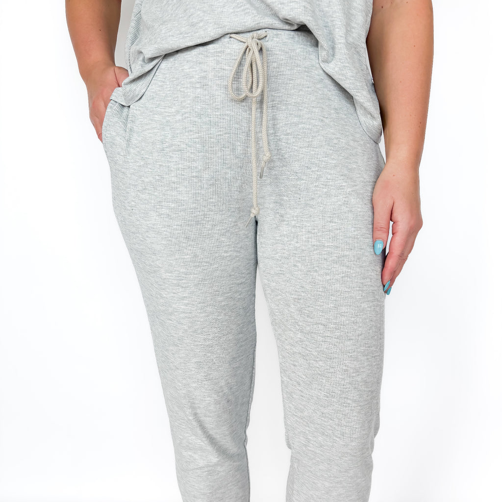 Gray jogger pants with a drawstring on a white background
