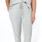 Gray jogger pants with a drawstring on a white background