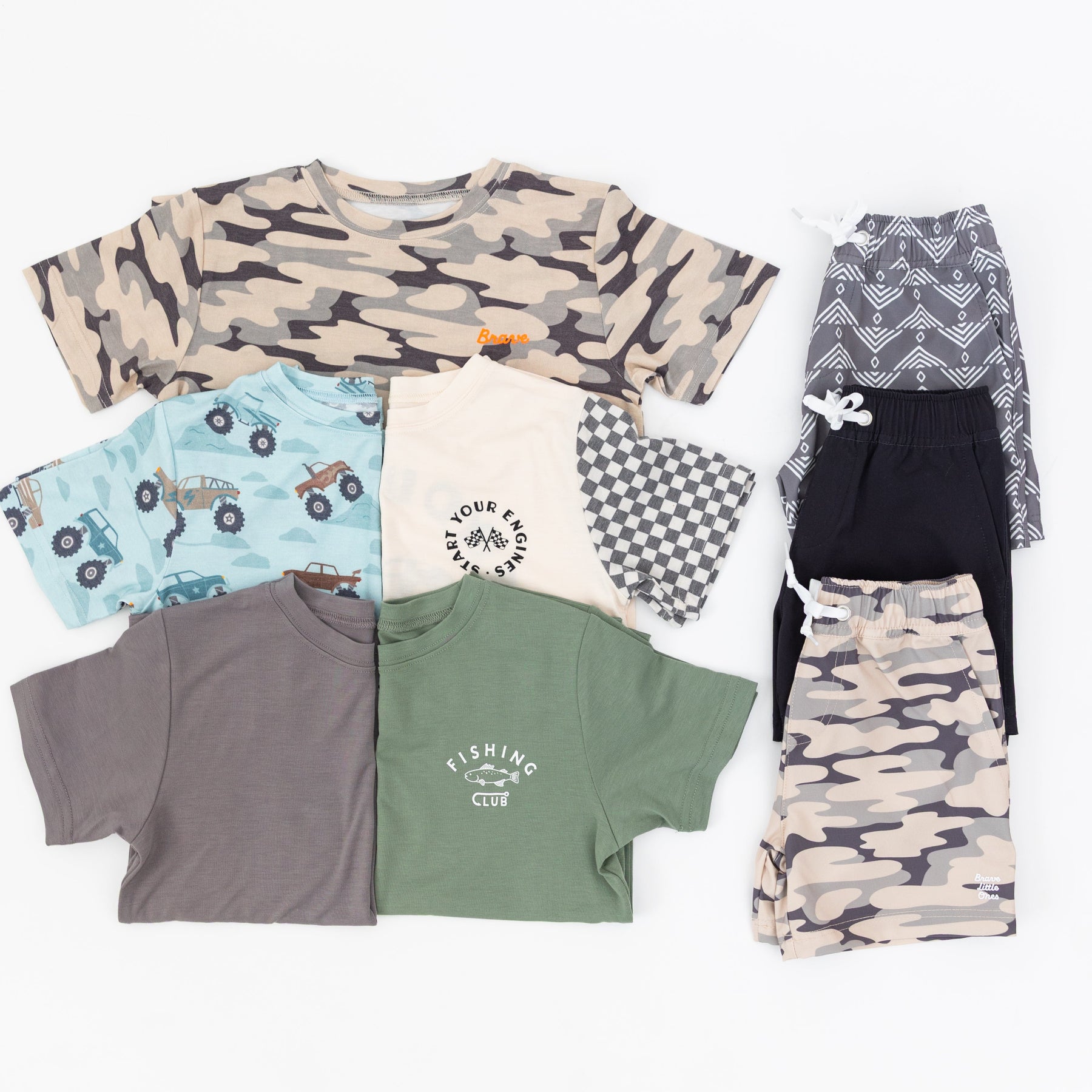 Collection of children's clothing including t-shirts and shorts on a white background