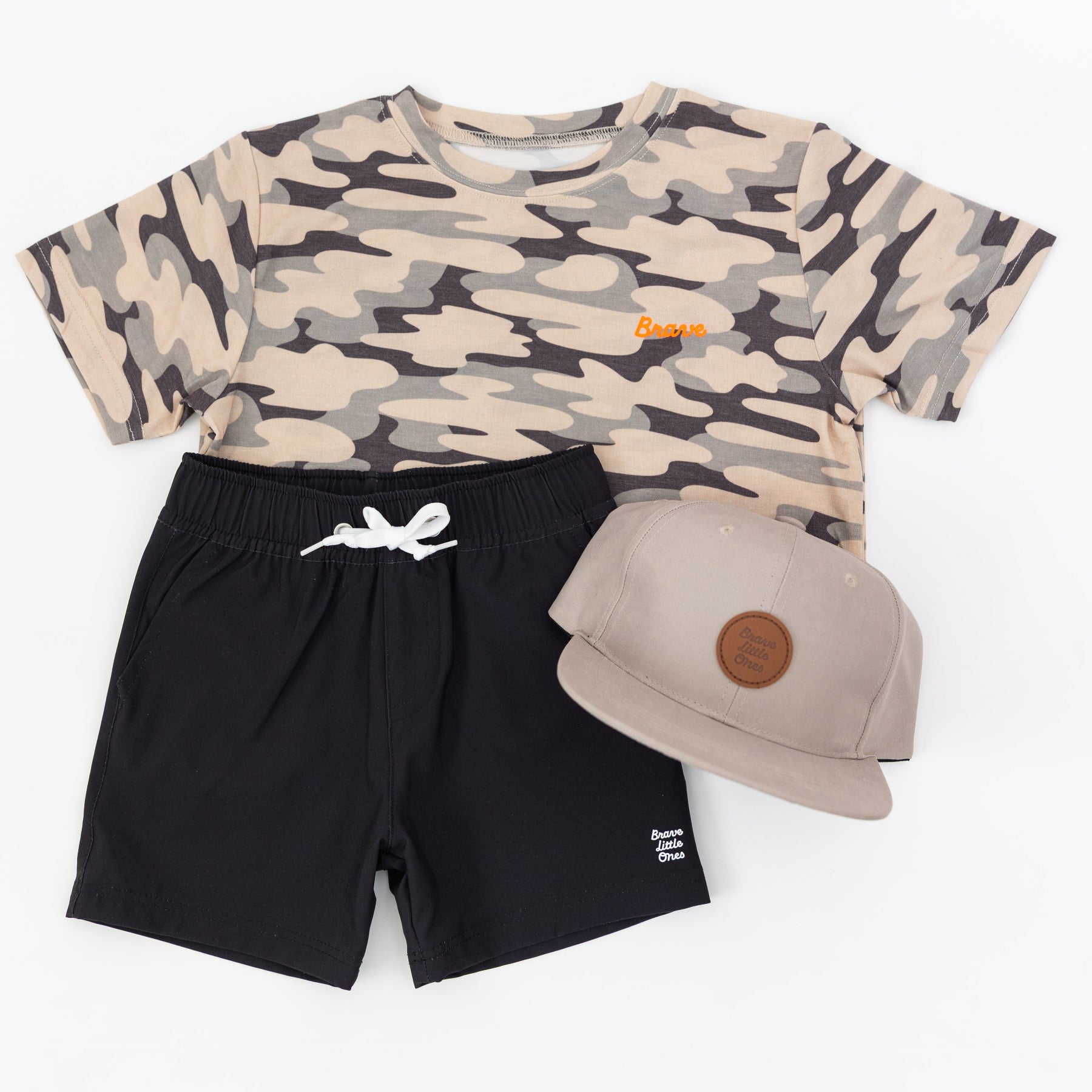 Camouflage t-shirt, black shorts, and taupe cap on a white background