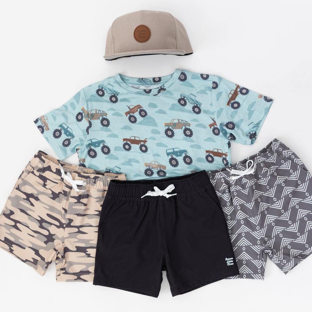 Children's clothing set with t-shirt, shorts, and cap on a white background