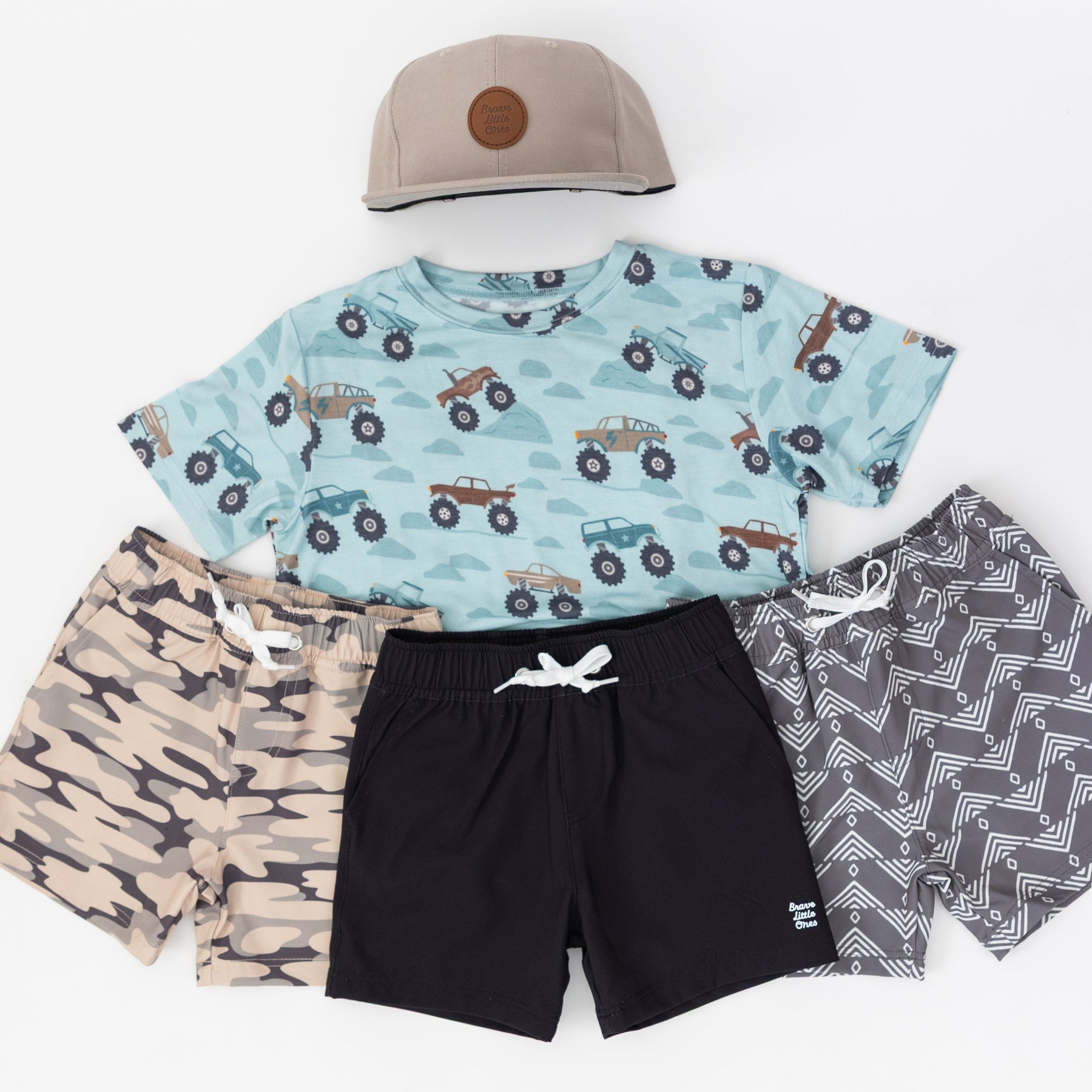 Children's clothing set with t-shirt, shorts, and cap on a white background