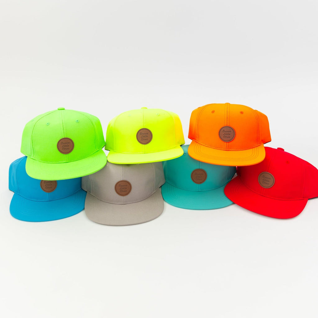 Seven colorful caps in a row on a white background