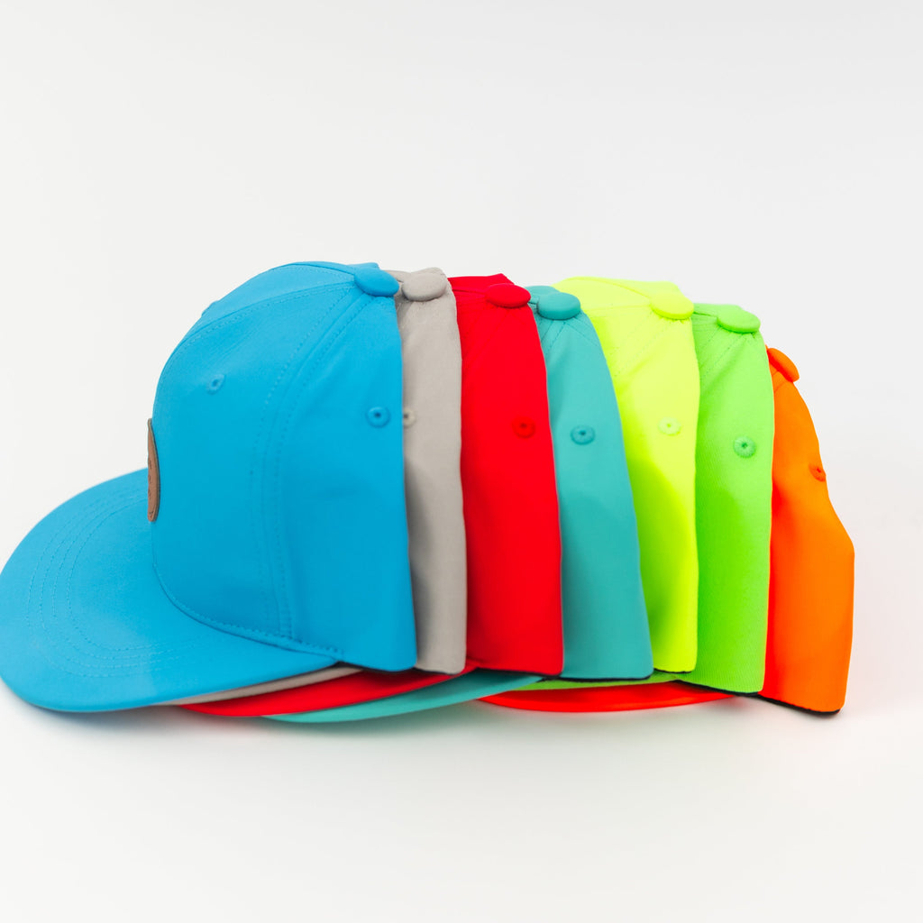 Stack of colorful trucker hats on a white background