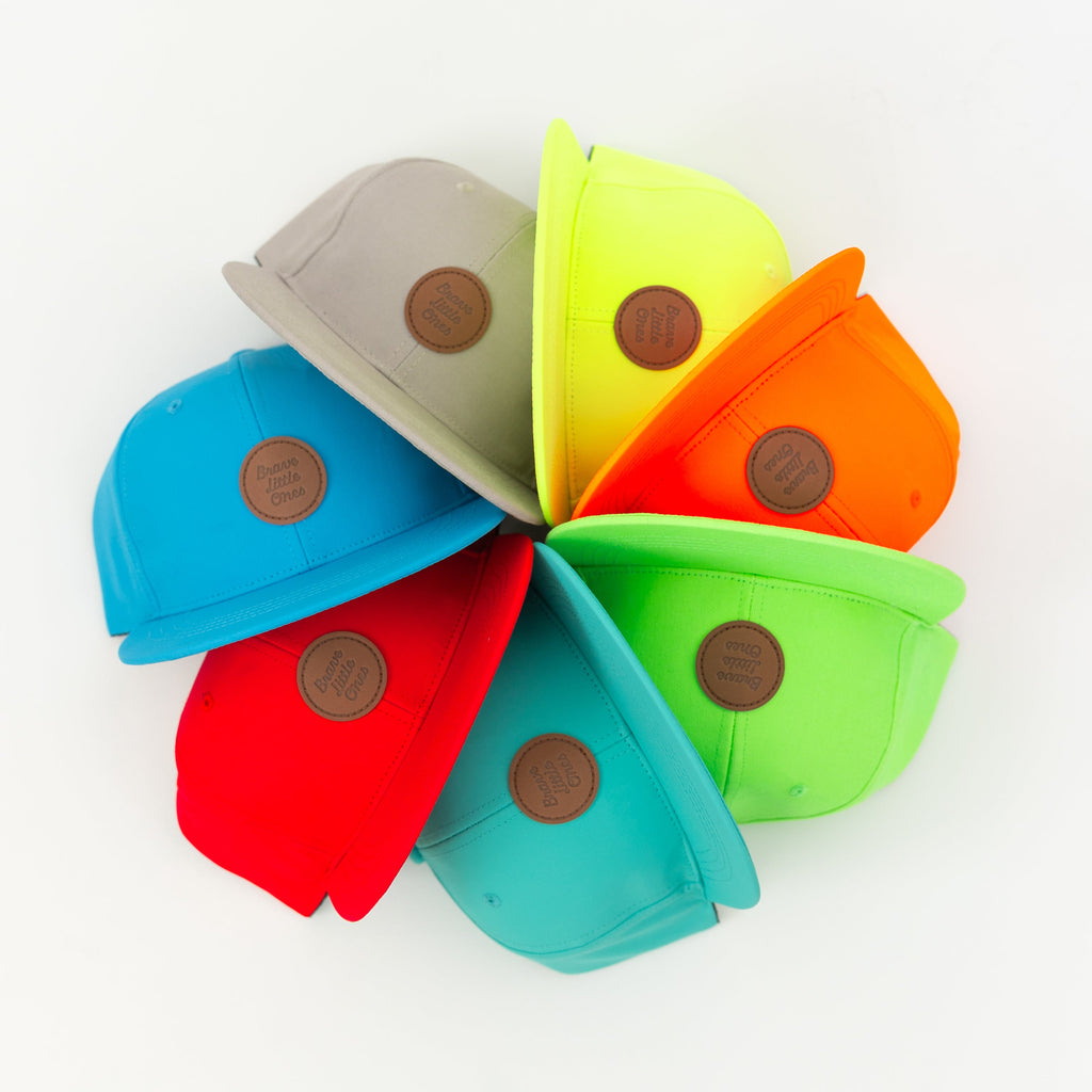 Colorful set of trucker hats arranged in a circular pattern on a white background