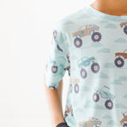 Close up shot of a light blue t-shirt with vehicle pattern on a white background