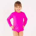 Child wearing a bright pink long sleeve two-piece swimsuit on a white background