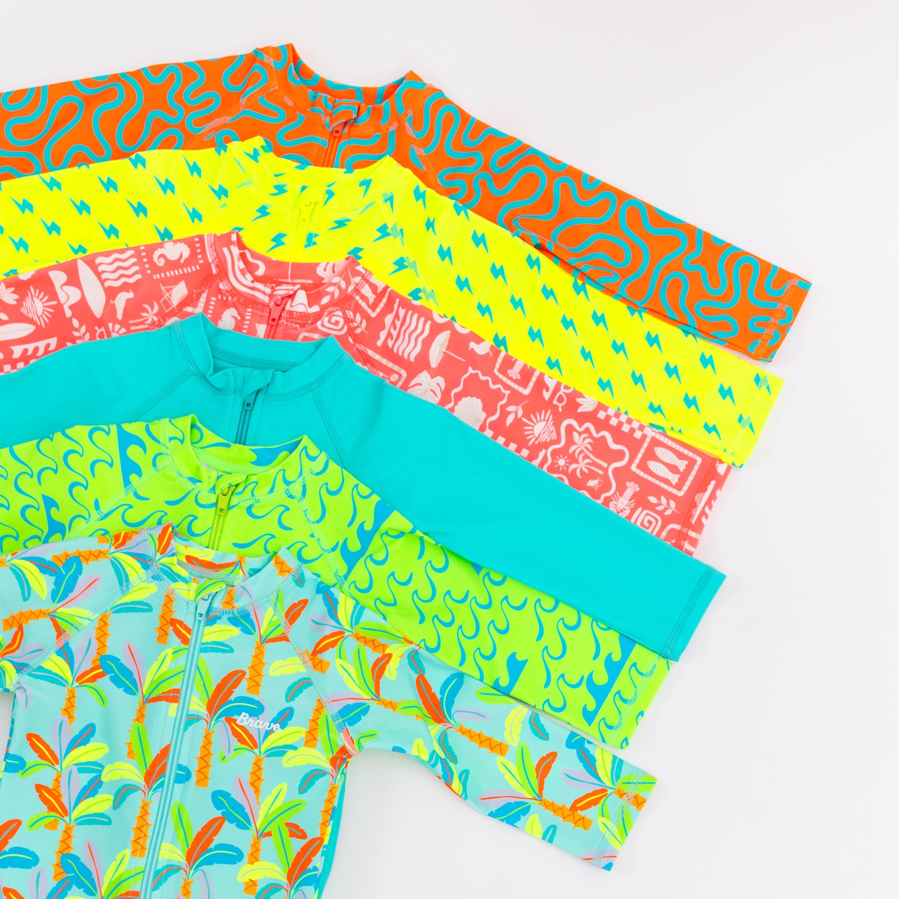 Colorful boy swimsuits stacked on a white background