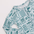 Baby romper with teal and white summer pattern on a white background
