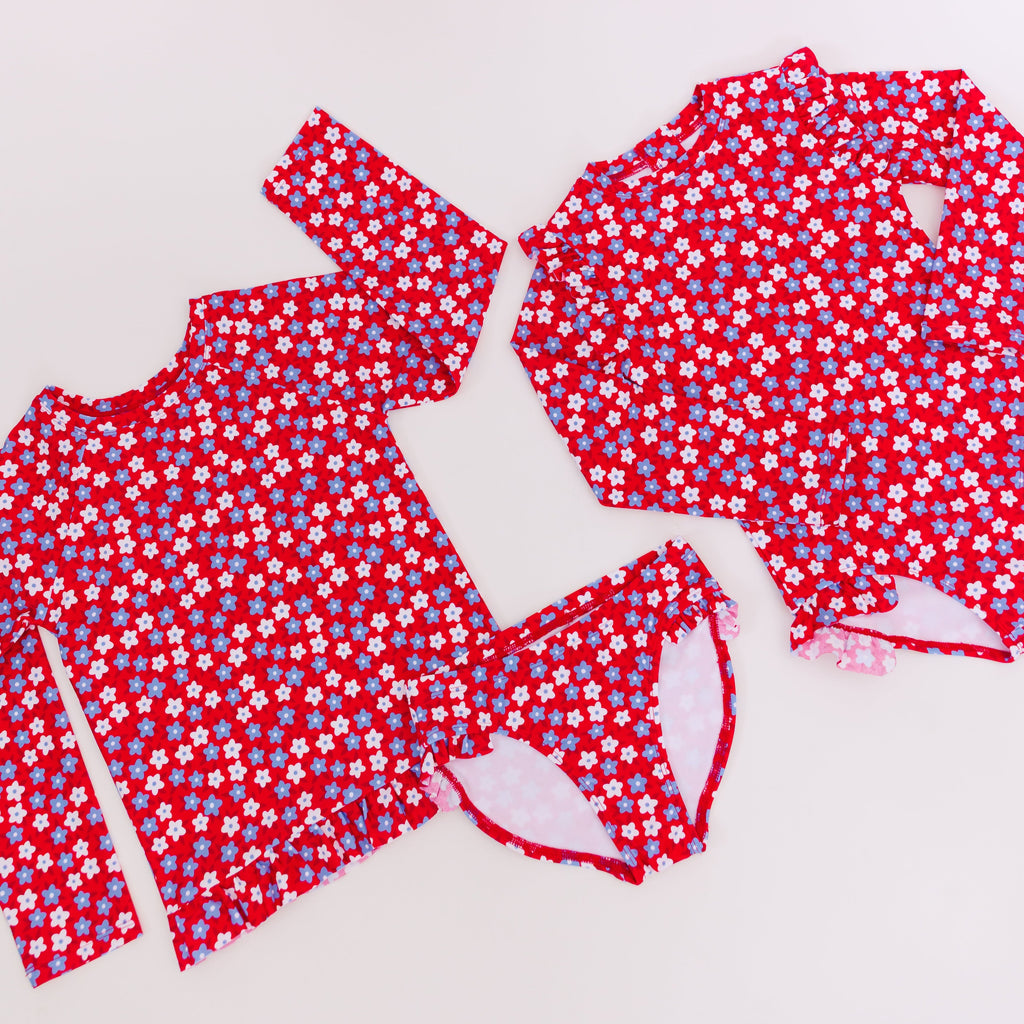 Red and white floral swimsuits on a white background