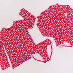 Red and white floral swimsuits on a white background