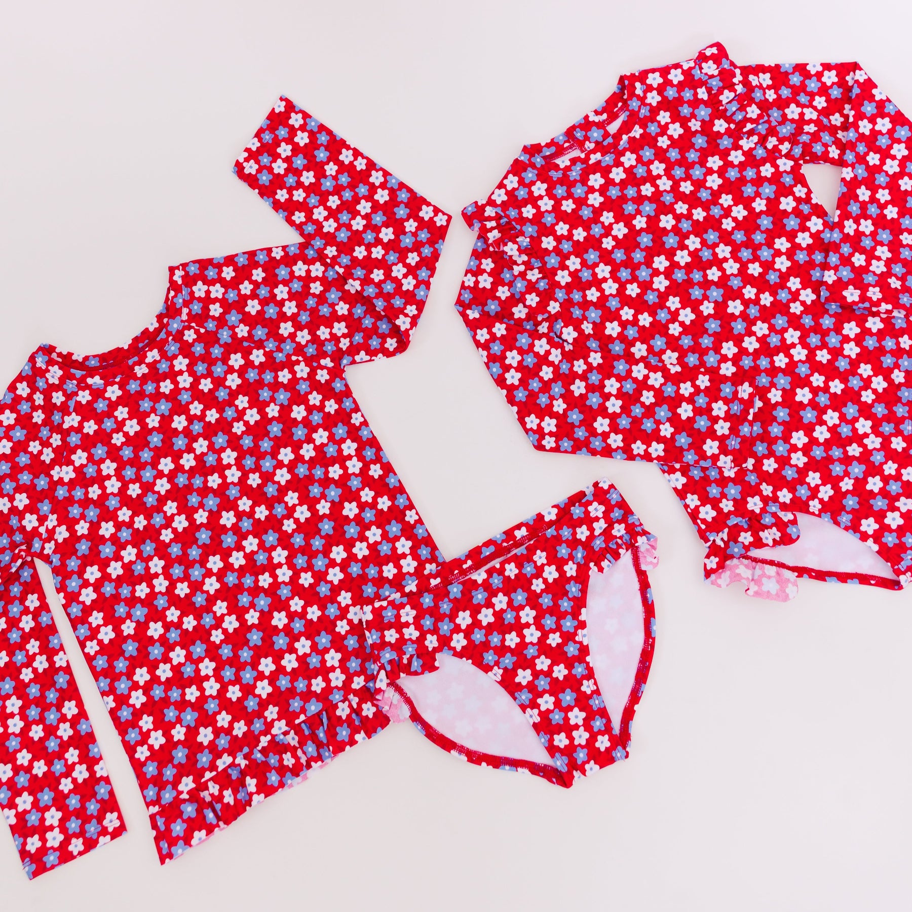 Red and white floral swimsuits on a white background