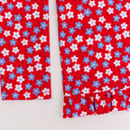 Close up shot of a blue and white floral swimsuit top on a white background