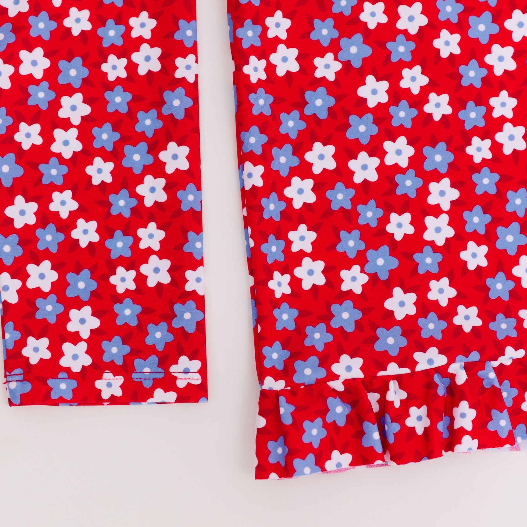Close up shot of a blue and white floral swimsuit top on a white background