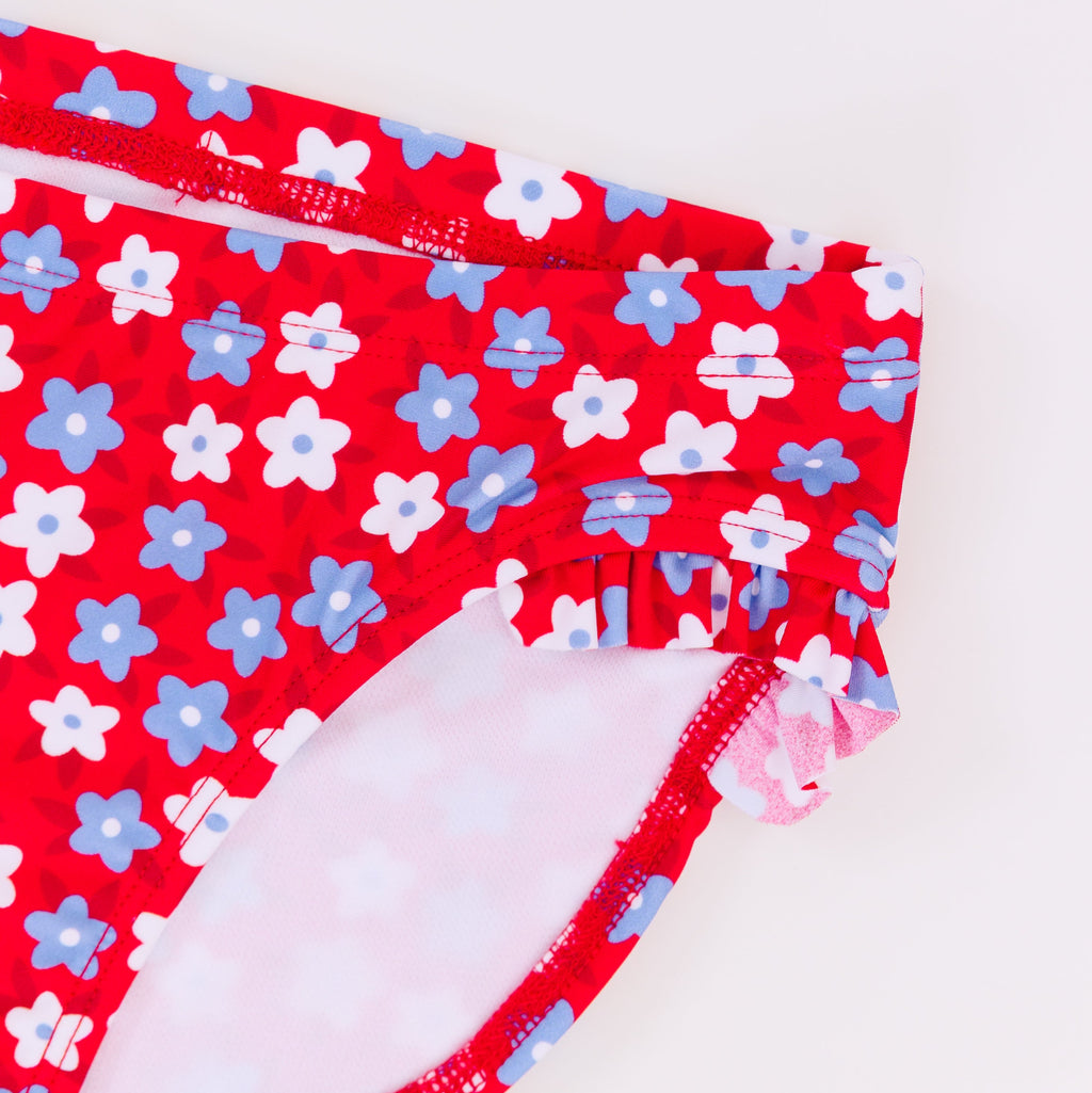 Close up shot of a blue and white floral swimsuit bottoms on a white background
